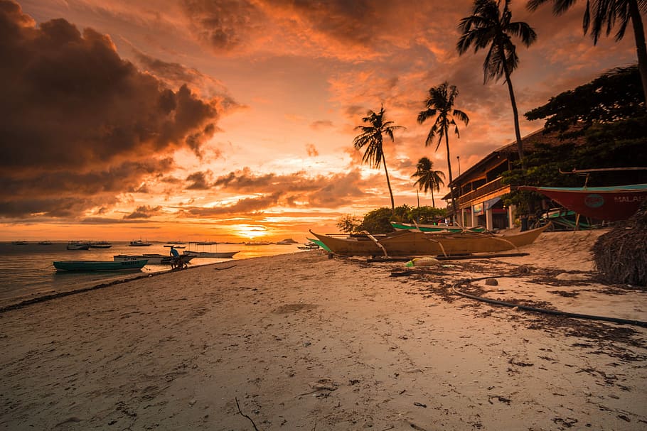 photography of beach resort during golden hour, boat near body of water during sunset HD wallpaper
