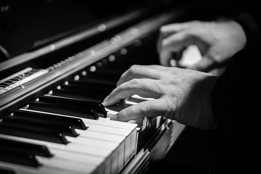 gray-scale photo of person playing a piano, hands, pianist, piano keyboard