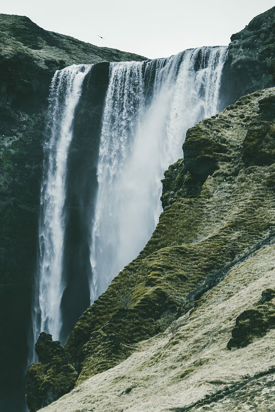 waterfalls near rock mountain, waterfall under white sky, skogafoss