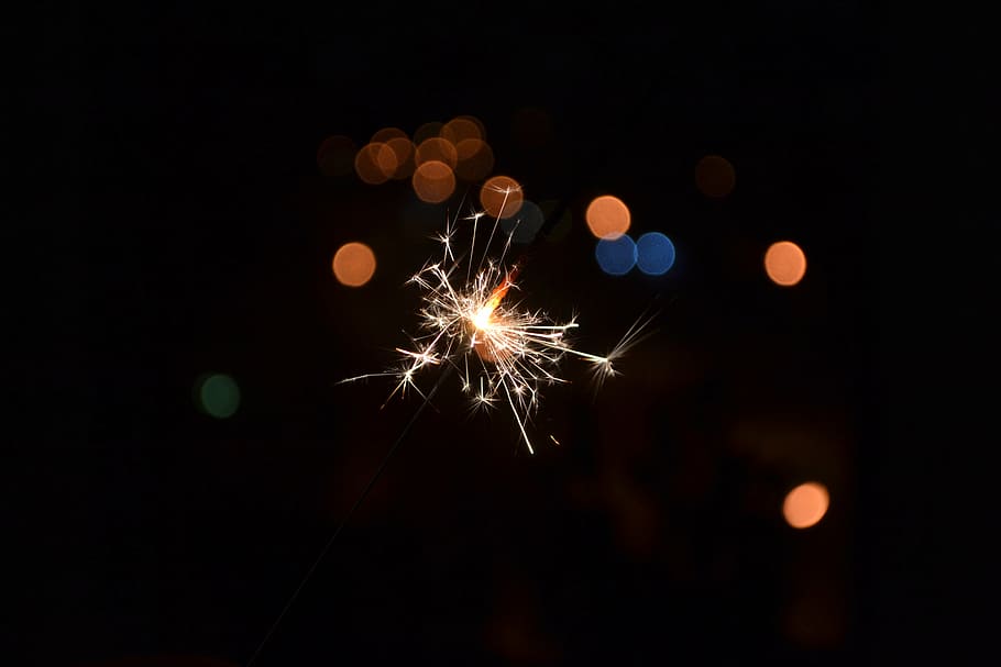 person holding firecracker, sparkler, holiday, firework - man made object HD wallpaper