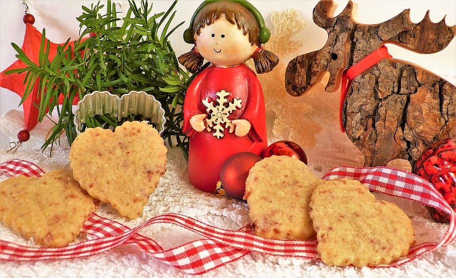 girl and moose figure beside brown cookies, advent, cookie cutter