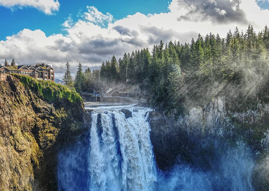 brown and white building beside waterfalls, time lapse photography of waterfall HD wallpaper