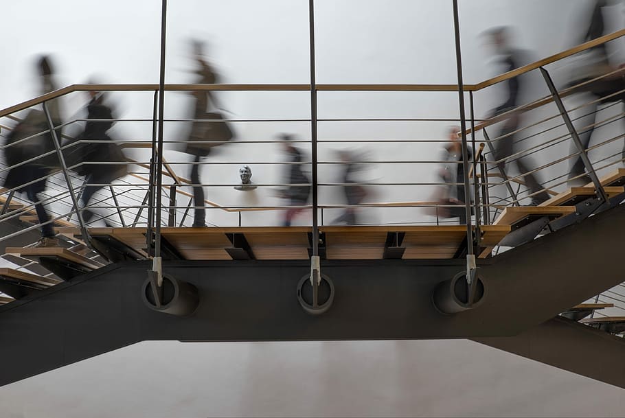 time lapse photography of people passing on bridge, low angle of people walking on brown and gray staircase HD wallpaper