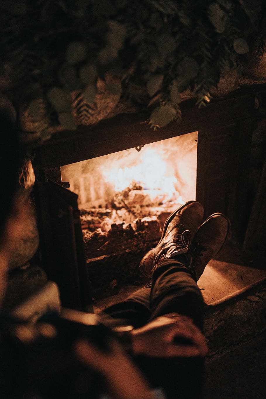 man sitting in front of the fireplace, black fireplace, boots HD wallpaper