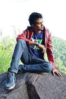 man in red jacket on rock, boy, pose, t-shirt, jeans, young HD wallpaper