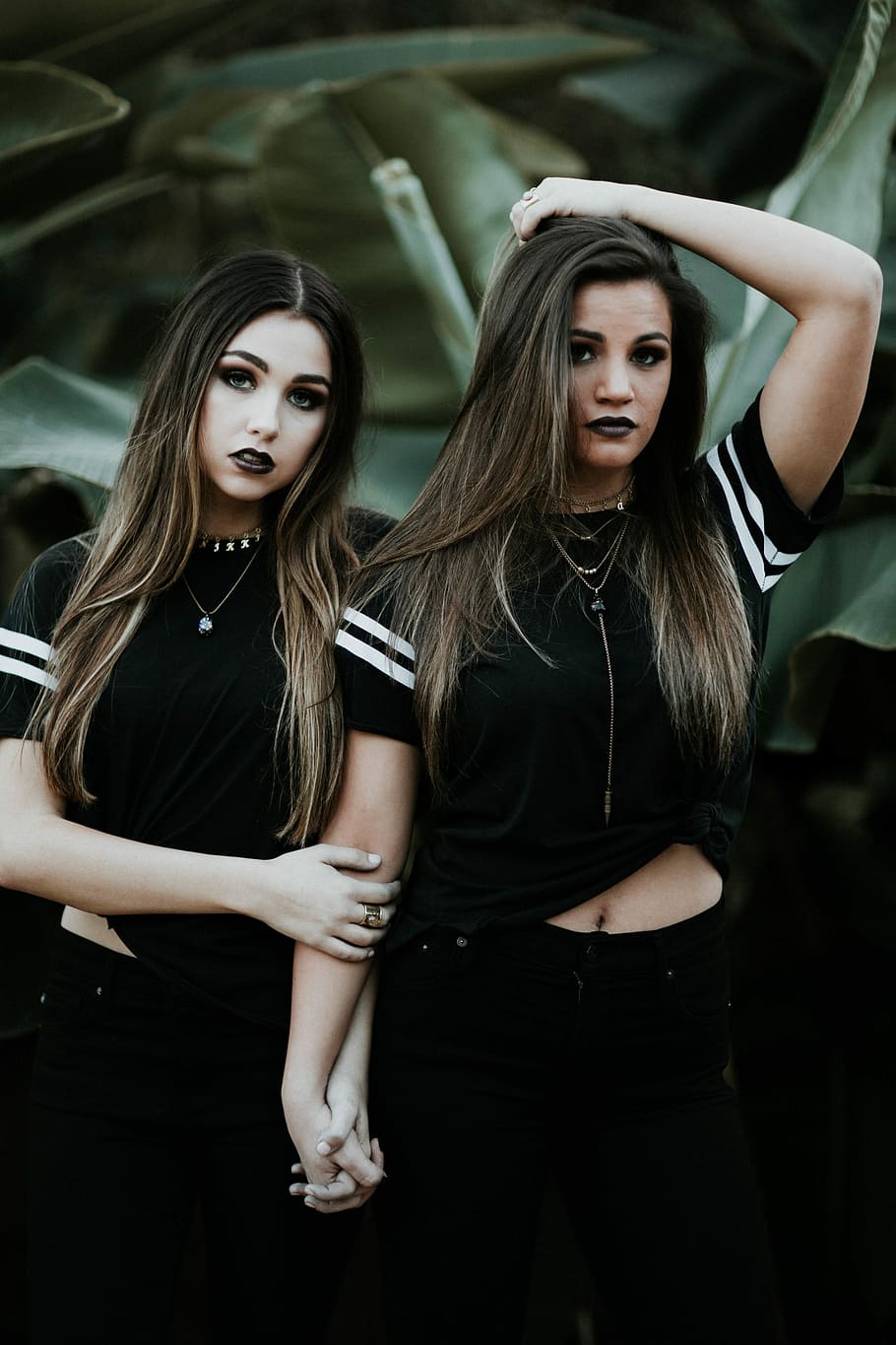 two women in black sleeve crop top and black pants holding hands HD wallpaper