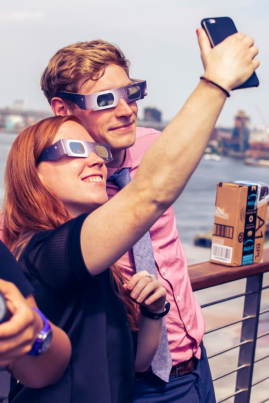couple taking selfie, man and woman wearing solar eclipse glasses while taking selfie HD wallpaper