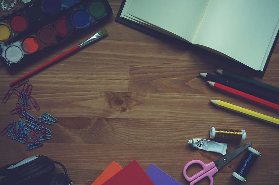 water color palette beside red brush and clips on brown parquet floor HD wallpaper