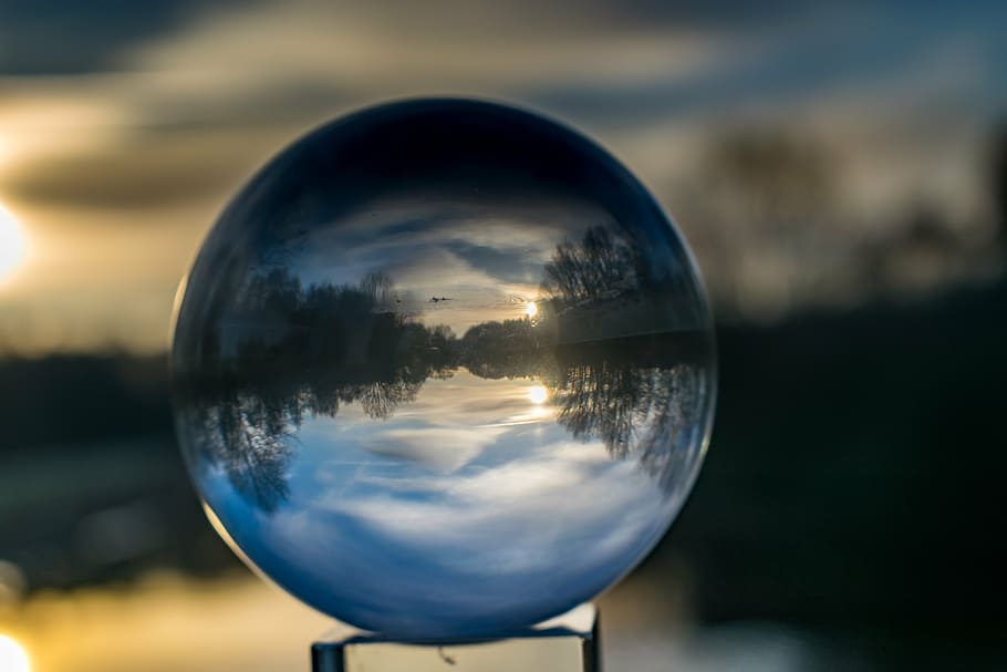 shallow focus photography of crystal ball reflecting lake, glass ball