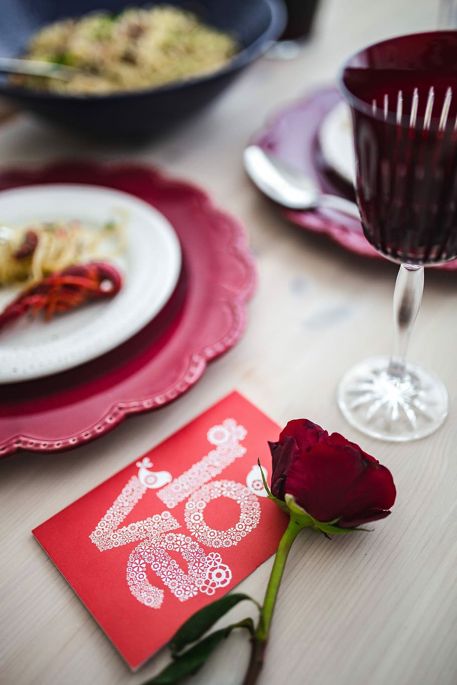 Fancy dinner with seafood pasta, crayfish and red wine by the table decorated with roses HD wallpaper