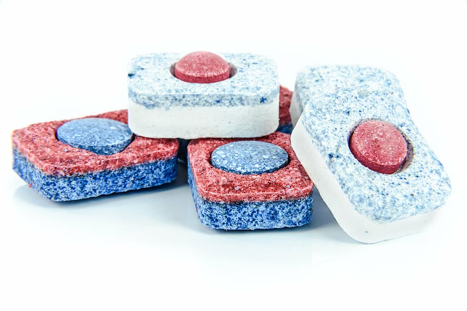 six red-blue-and-white ornaments on white surface, dishwasher