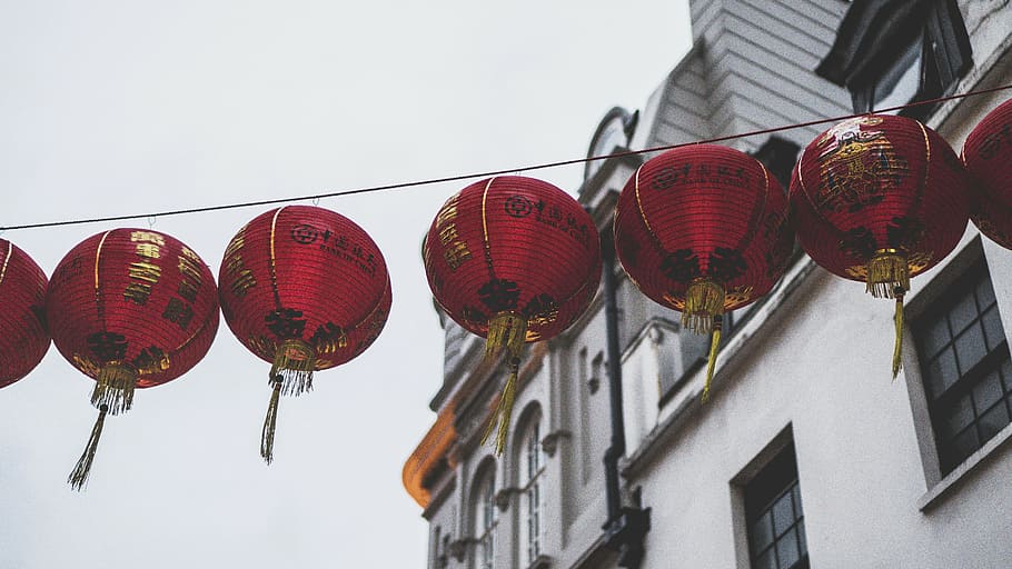 red paper lantern hanged on string near building, art, design