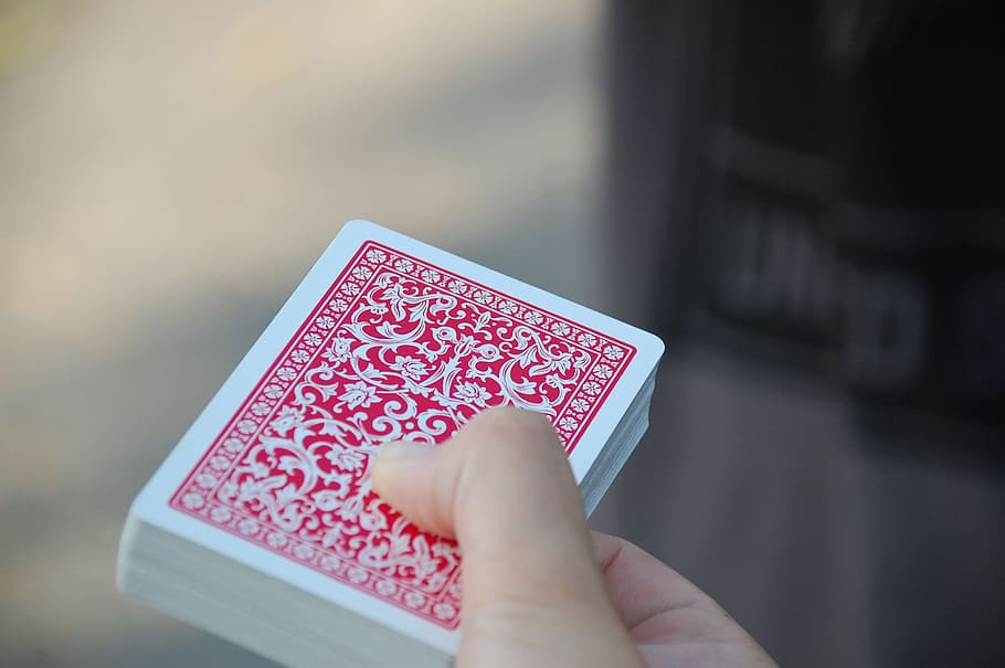 person holding red and white playing card deck, letters, magic HD wallpaper
