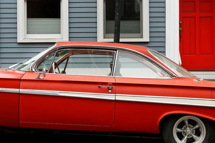 classic red coupe parks beside gray and white wooden house, red car parked near house HD wallpaper