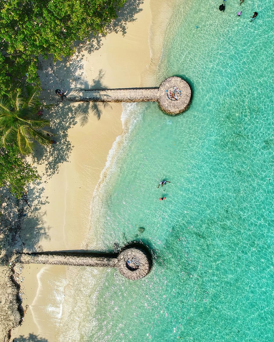 birds eye photography of island, aerial view of shore during daytime