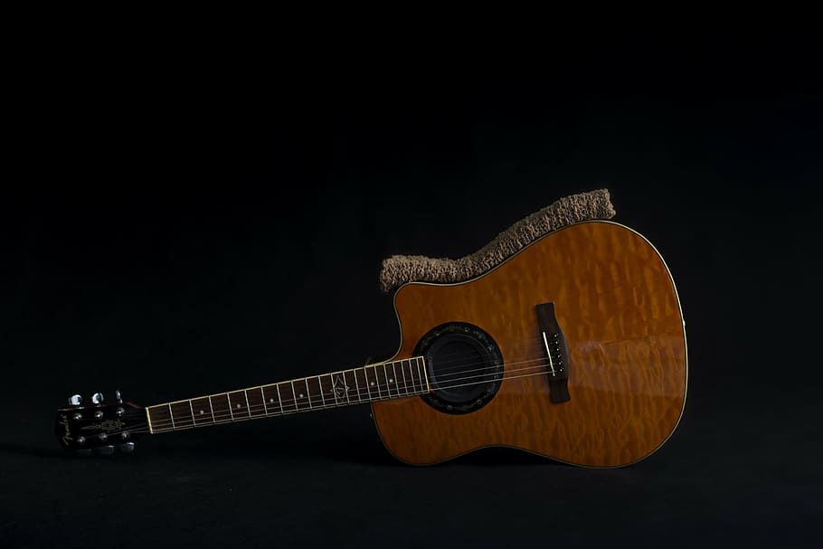 brown steel string guitar on floor, fender guitar, background for newborn