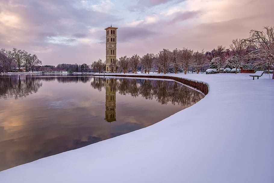 tower near lake during daytime, brown concrete building near river during daytime HD wallpaper