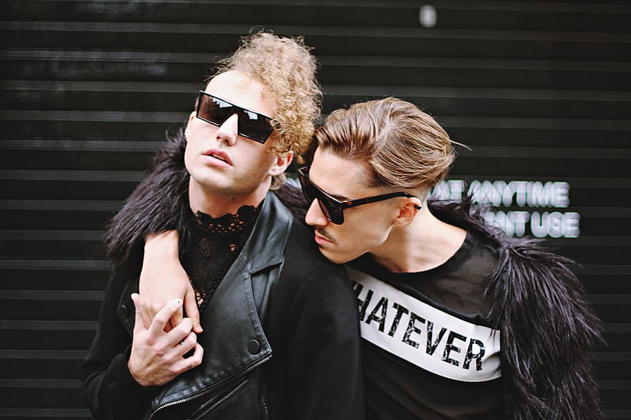 man putting his right hand on man's shoulder, two men wearing black sunglasses and black shirt HD wallpaper