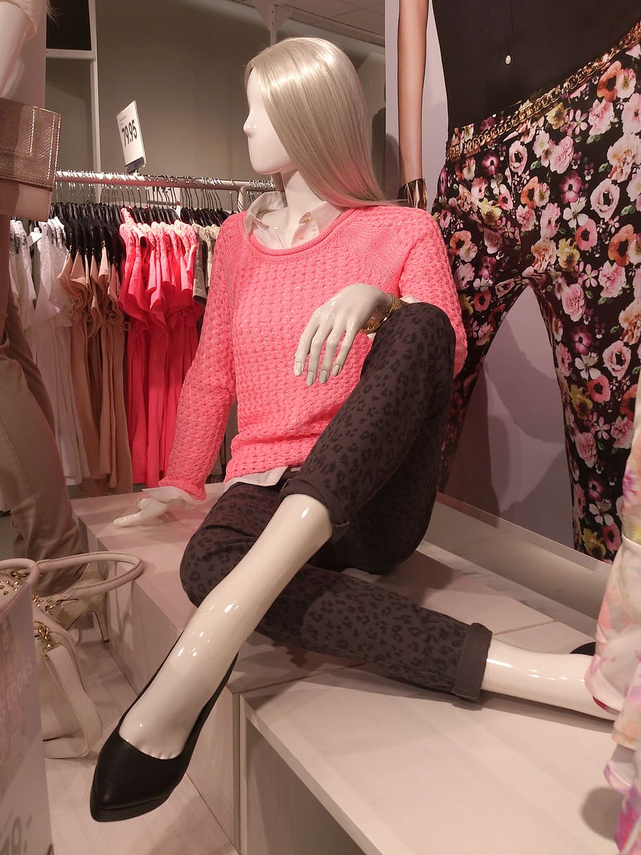 A group of mannequin legs displayed outside a casual clothing shop, each  wearing a different pair of colorful leggings or tights Stock Photo - Alamy