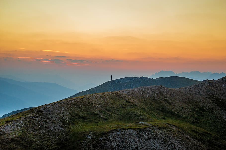 green grass filled mountain under orange and blue sky, sunset HD wallpaper