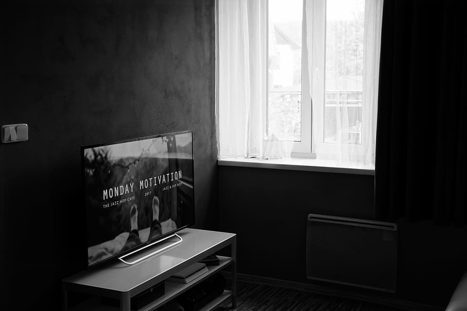 Gray Scale Photo of Flat Screen Tv on Top of Wooden Tv Rack, apartment