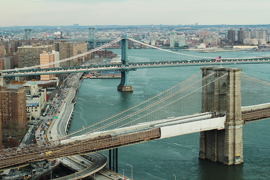 photo of gray concrete suspension bridges above body of water HD wallpaper