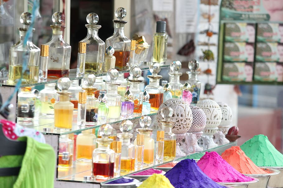 display of fragrance bottle collection outdoors, assorted decanters on glass rack, HD wallpaper