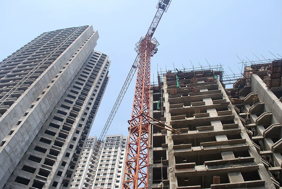 low angle photography of tower crane near buildings, Construction