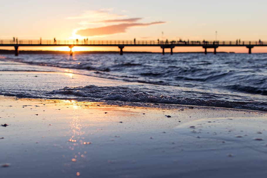 black concrete bridge on body of water, time lapse photography of beach seashore HD wallpaper