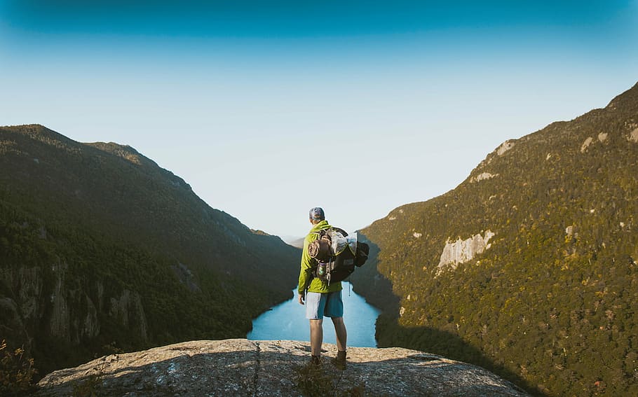 man standing on mountain, nature, mountains, trees, river, sky HD wallpaper