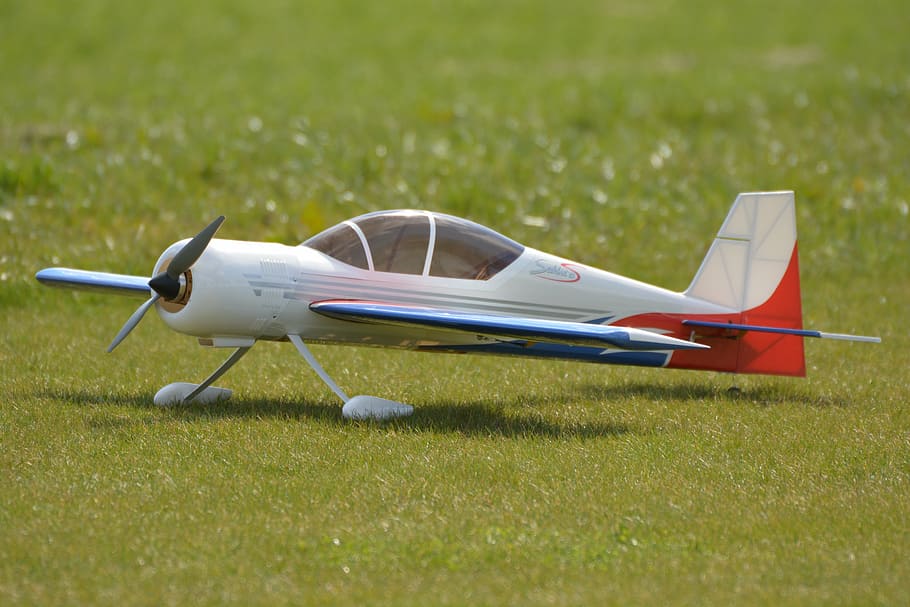 white and red airplane toy on grass, modelling aircraft, model airplane HD wallpaper