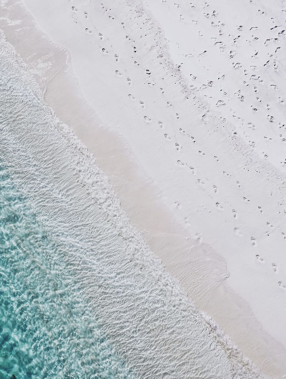 aerial photography of white sand seashore and green water beach, aerial photo of white sand beach