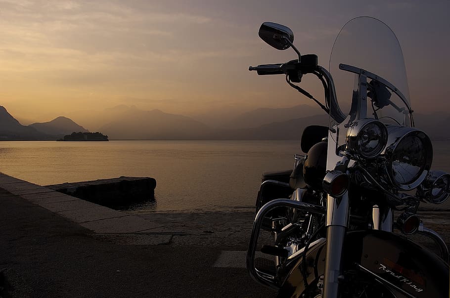 black cruiser motorcycle parked near seashore, Harley, Italy