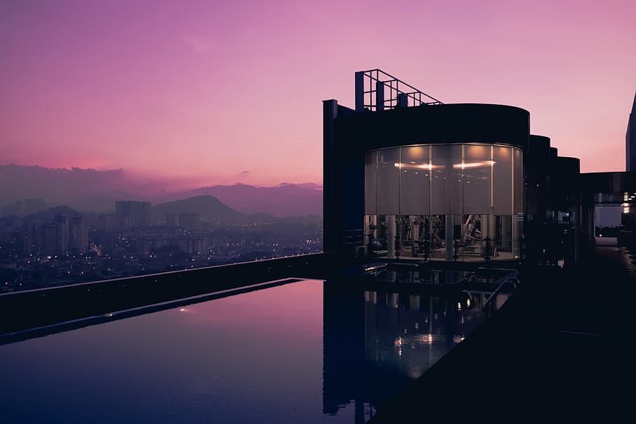 Rooftop swimming pool at sunset at a hotel in Malaysia, architecture HD wallpaper