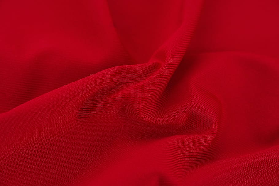 red textile, fabric, color image, copy space, detail, macro, clothing