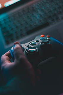 person holding black game controller, selective focus photography of person holding black Xbox 360 controller HD wallpaper