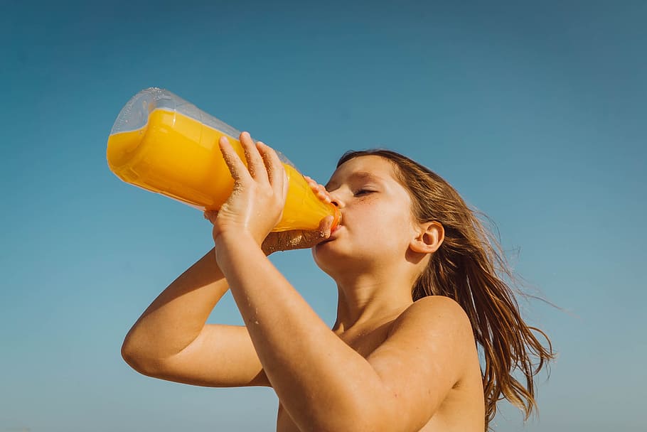 girl drinking juice during daytime, people, kid, child, thirsty