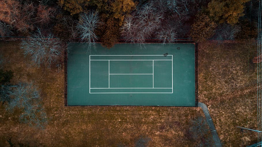 flat-lay photography of tennis court, aerial photography of badminton court beside trees