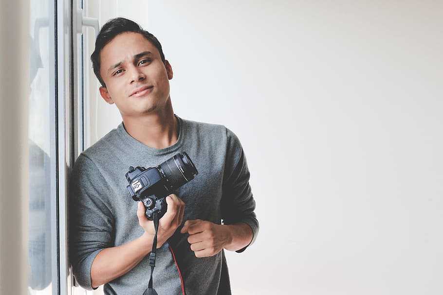 man leaning on window pane, camera, person, camera - photographic equipment HD wallpaper