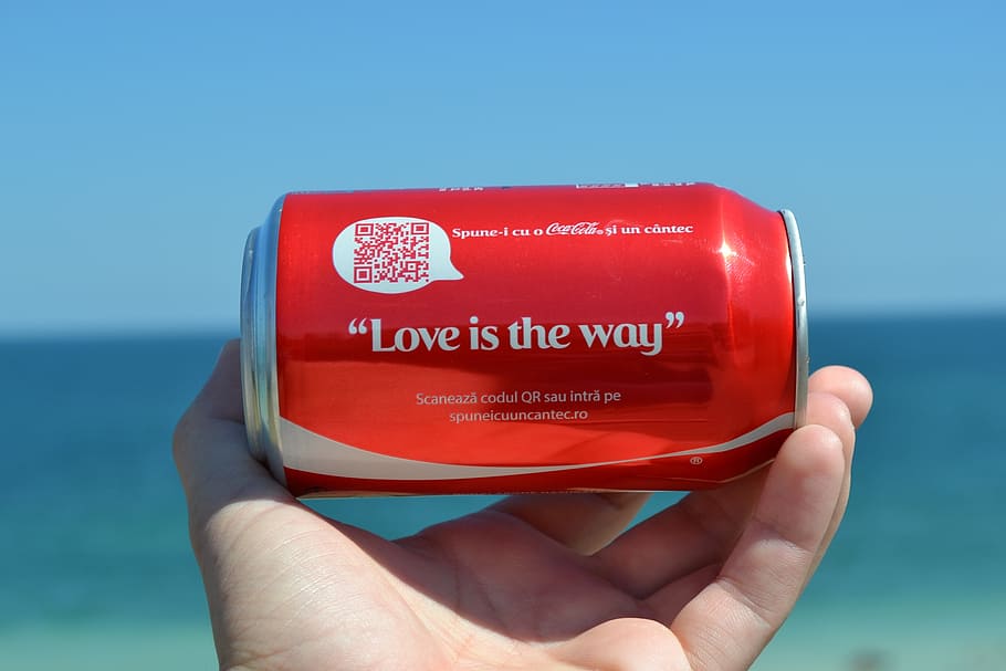 person holding Love is the way quoted Coca-Cola soda can, coca cola