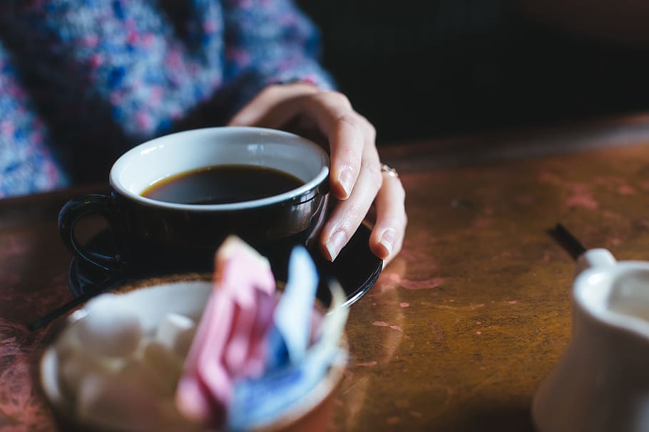 person drinking tea, person sitting near brown table, black, teacup HD wallpaper
