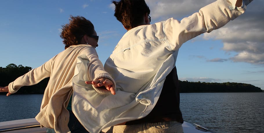 man and woman standing on top of boat, flying, friends, fun HD wallpaper