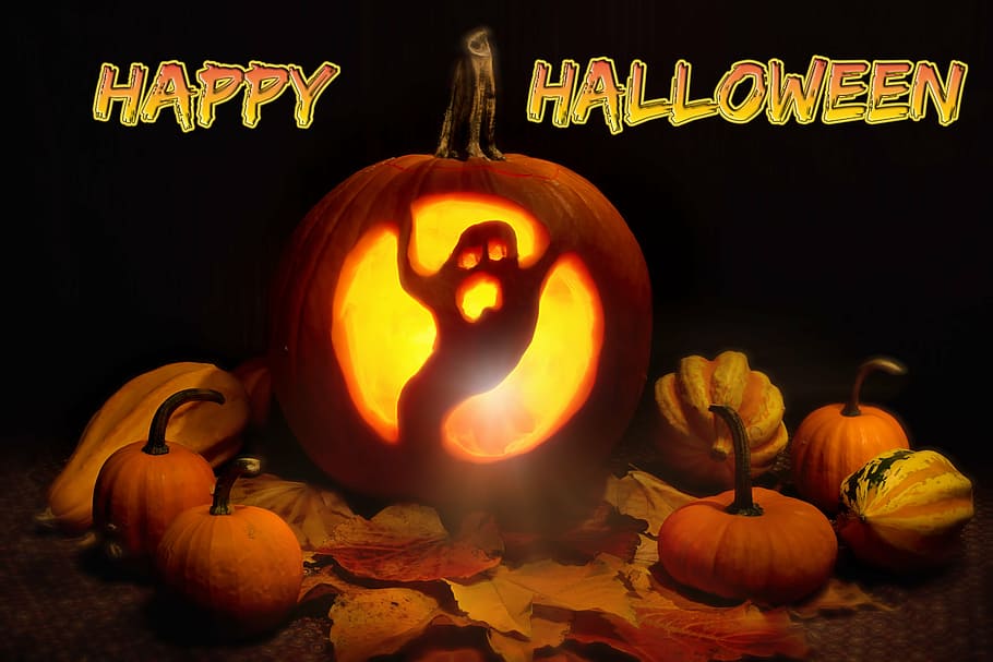 ghost carved pumpkin with Happy Halloween text overlay, lit, orange