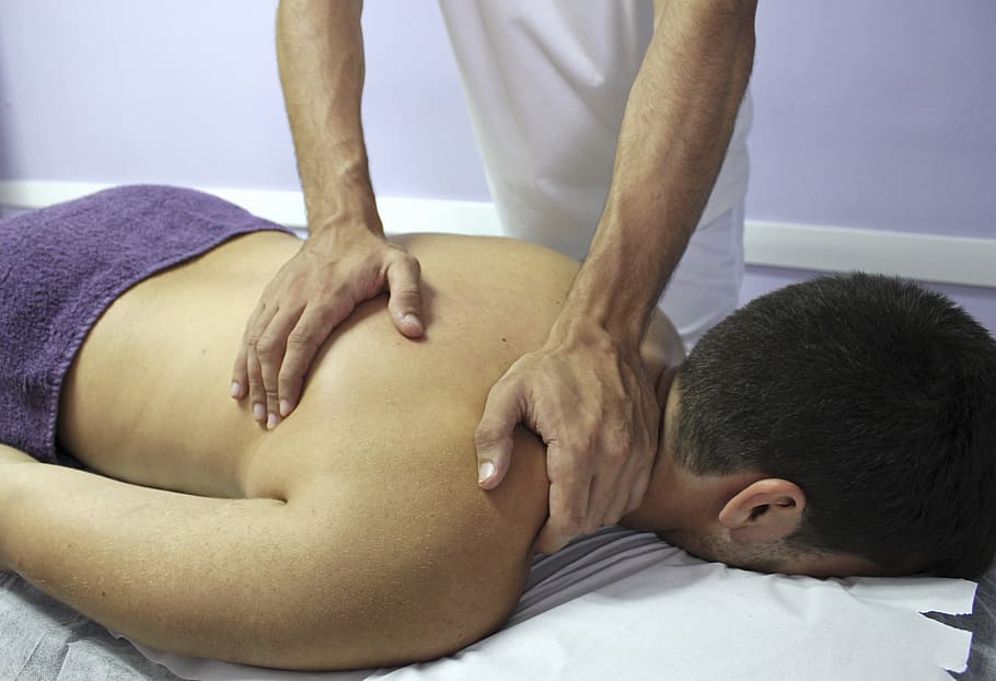 person massaging man on bed, Wellness, Osteopathy, Therapies