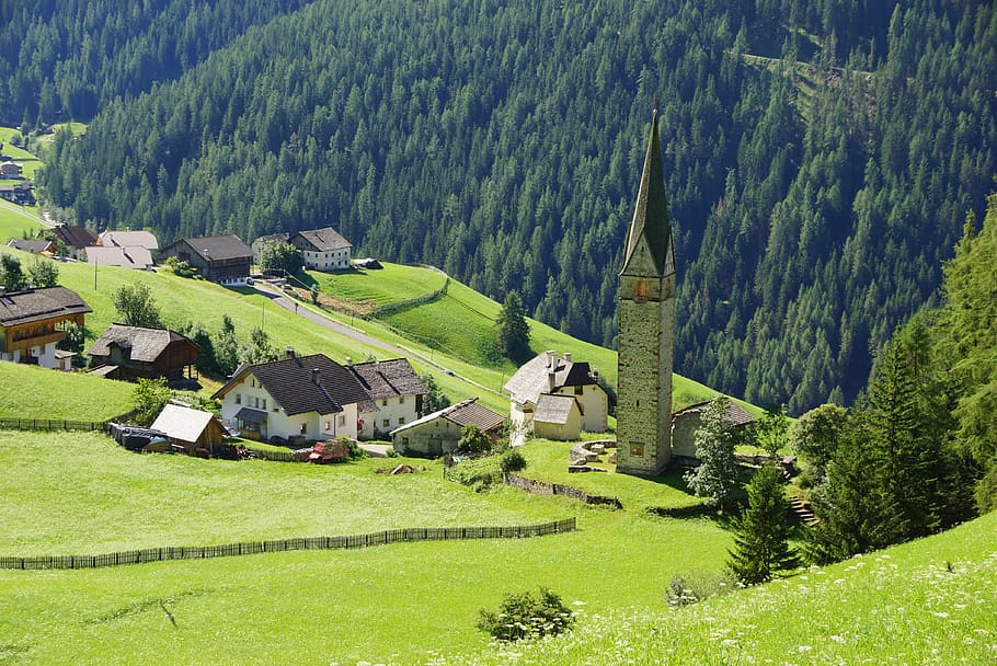 high angle photo of village on mountain slope, dolomites, la val
