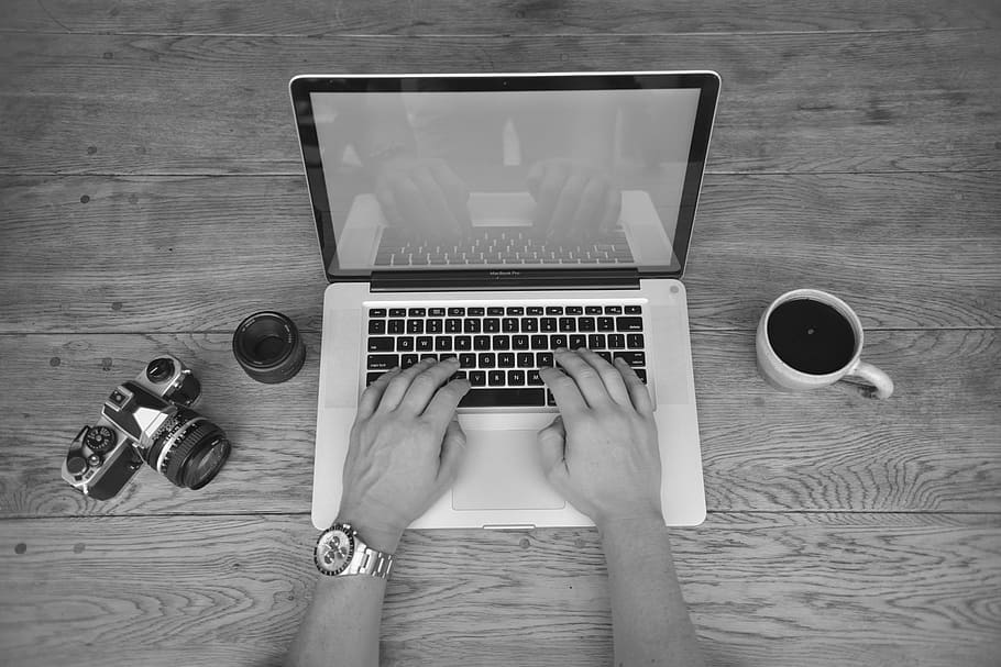 grayscale photo of person's hands typing on black and white laptop HD wallpaper