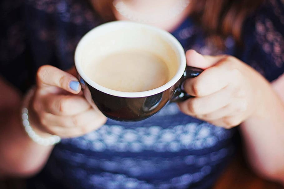 woman showing black and white ceramic cup, blur, breakfast HD wallpaper