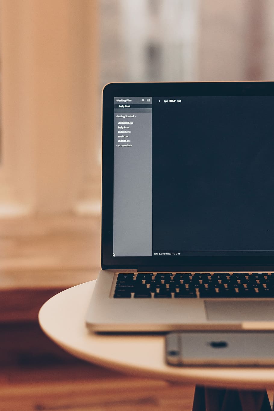 MacBook Pro displaying files, gray laptop computer on top white table HD wallpaper