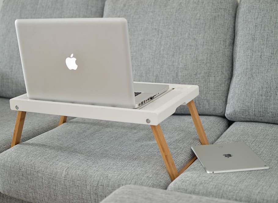 silver MacBook on laptop table on sofa, open MacBook on table HD wallpaper