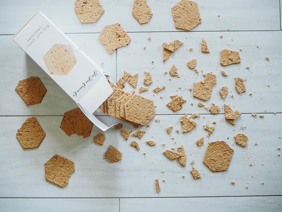 biscuits with box on gray surface, pieces of biscuits on floor HD wallpaper